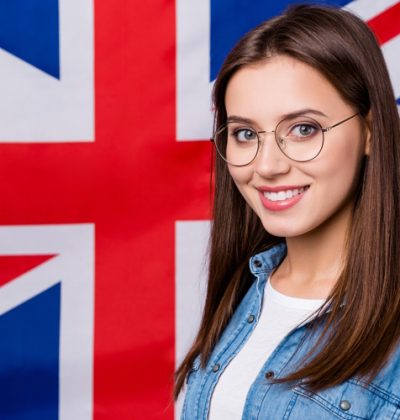Close up photo of positive smart confident high school girl enjoy study abroad in international scholar, courses lectures wear good look clothes isolated over british flag background