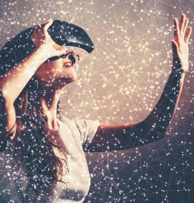 Young woman using a virtual reality headset with conceptual network lines