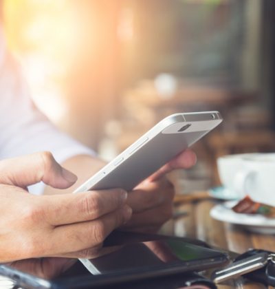 Young man using smartphone connection, always connected concept