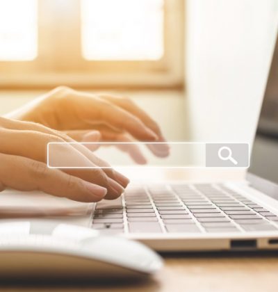 Searching information data on internet networking concept. Hand of male typing text on laptop keyboard